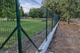 Building a concrete foundations with metal mesh panel fence of a kindergarten in Dobrich